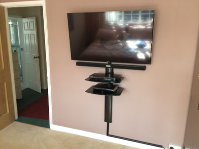 mounting LCD LED TV on the wall frees up floor space, shelving unit for sky and DVD blu-ray, sound bar with bluetooth and wireless subwoofer.