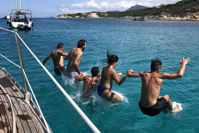 Saut groupé de 5 personnes dans l'eau au mouillage de l'Algaa