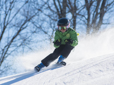 Teilnehmer auf Skipiste beim Skifahren - erlebe mit uns das Schneesportlager im Winter