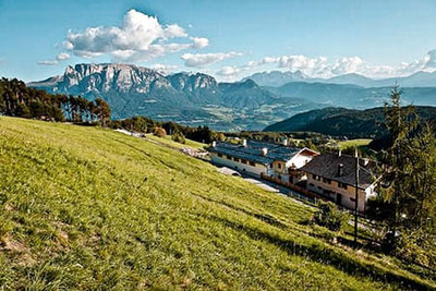 Hotel & Gasthof Bad Siess am Ritten mit traumhaftem Panoramablick auf Schlern und Dolomiten, umgeben von Wiesen und der idyllischen Natur Südtirols.