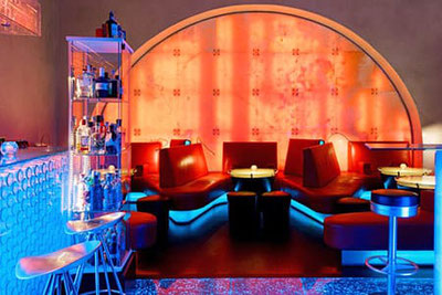 Die Grifoncino Cocktailbar in Bozen mit Ihren Glasfronten die in verschiedenen Farben sehr ansprechend beleuchtet werden.