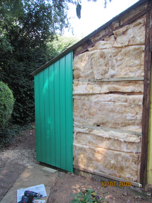 New recycled plastic cladding and insulation being put back in