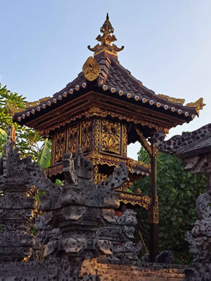 A small, ornate home temple richly decorated in Pemuteran.