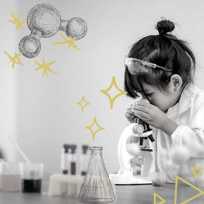 A little girl in a lab coat studying engaging in inquiry with a microscope