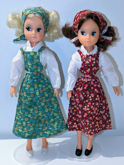 Two Squishhead Basic Fleur dolls in their outfits wearing flats with a bow.