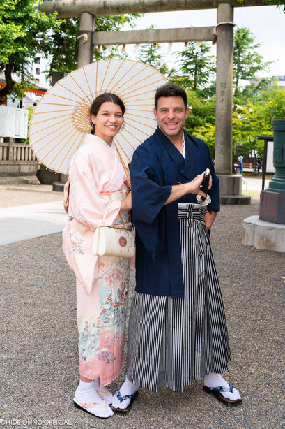 Honeymoon couple in traditional kimono walking hand in hand at Sensoji Temple, Tokyo