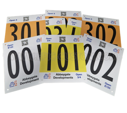 Custom printed CTT-compliant vinyl time trial race numbers for Team MK, designed for cycling time trials with sponsor branding, rider numbers and event categories.