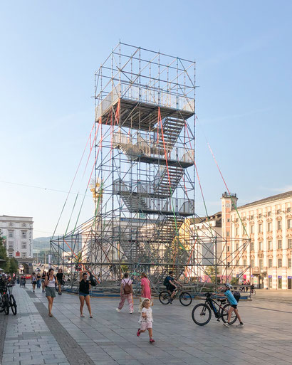 photo of the construction site of a public tower made of scaffolding on Linz's main square for the Ars Electronica Festival - architectural art installation for the University of Arts Linz
