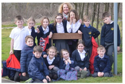 Mrs Alison George from Langar CE Primary School with students from the Eco Club unveiling the Wiggly Waggly Way footpath sign 