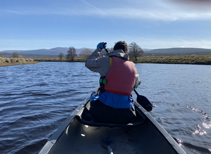 Image of Jamie in the front of the Canoe paddling