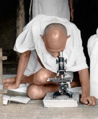 Mahatma Gandhi at the microscope observing leprosy germs at Satyagraha Ashram, Sevagram, c. 1940.