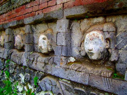 masks in a temple-wall