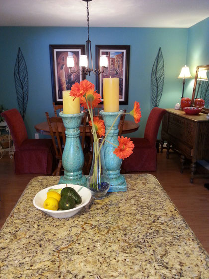 Dominant turquoise wall colour coordinated from living room, rust secondary colour