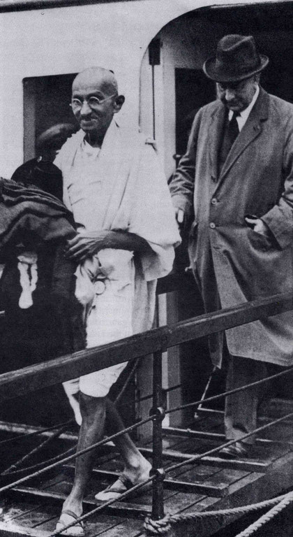 Mahatma Gandhi disembarking from the ferry at Folkestone, UK., with a British Government official.