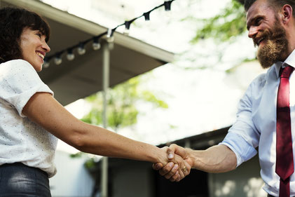 Man and woman shaking hands.