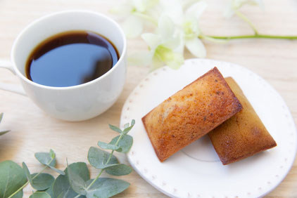 フィナンシェのお皿とコーヒーの入ったマグカップ。