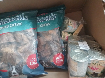 Karton mit Dosen Nassfutter und großen Tüten Hundesnacks als Spende für das Tierheim Flensburg, gespendet von Maritta, Ela, Sven, Laura, Sabine, Thorsten, Adele und Uli.