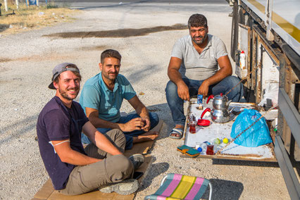 Abdul, his truck friend and Bastian having tea break