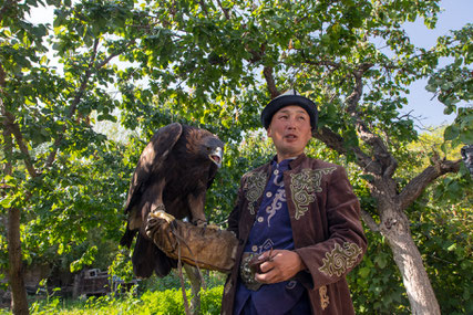 Ruslan with his 12 year old eagle in the backyard of his house in Bokonbaevo