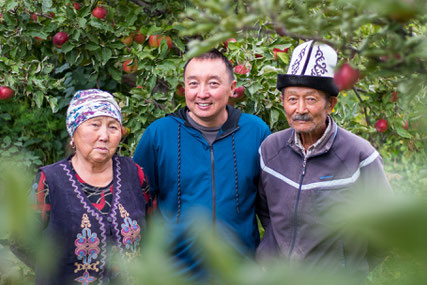 Bakydbek, his mum and dad in the backyard of their house