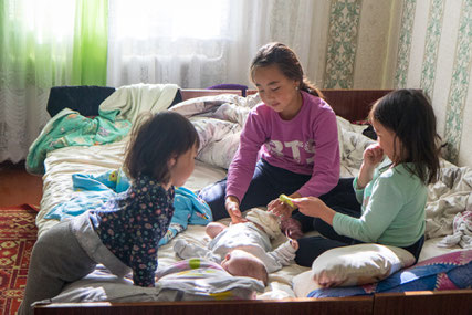 The elderly sisters taking care of the newborn