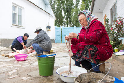 Bakydbeks mum is cleaning the sheeps intestines.