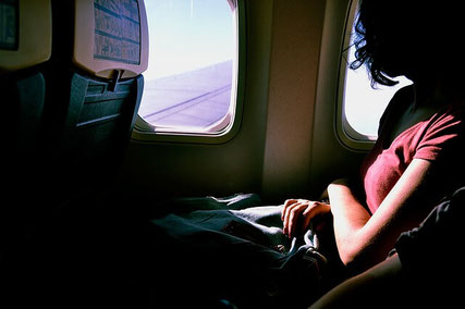 Nervous woman on airplane.