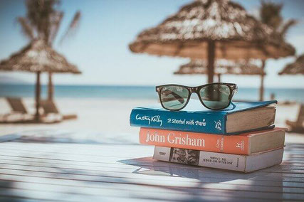 Relaxing on beach with books. 