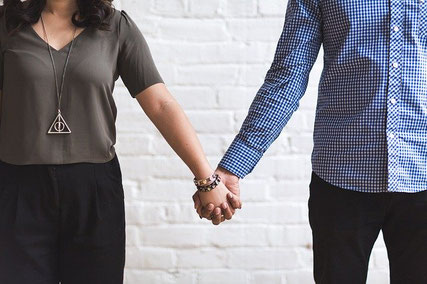 Couple holding hands.