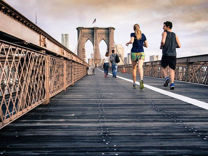 People running by Brooklyn Bridge.