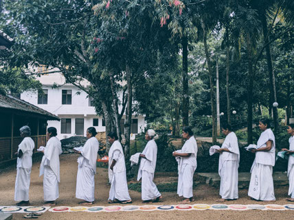 These sisters are yet to become Nuns. They are not ordained yet. Their plate is smaller and their clothes are white-colored.