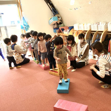 今日はテラスに出る前、室内で平均台で遊びました。落ちないようにバランスを取って慎重に歩いたり、猫になりきってハイハイで移動する子もいました。平均台から平均台にジャンプして移動したりと、室内でも体を動かして遊びました。