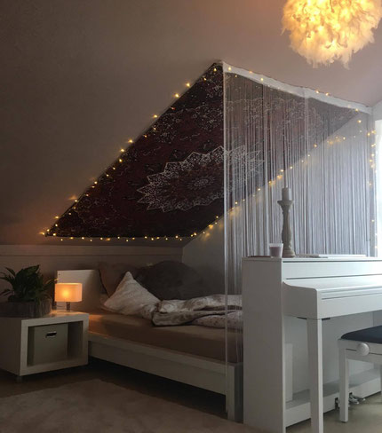 Wandtuch an Dachschräge mit Lichterkette und Faden Vorhang