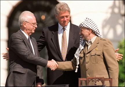 President Clinton presides over ceremonies marking the signing of the 1993 peace accord between Israel and the Palestinians on the White House lawn with Israeli Prime Minister Yitzhak Rabin, left, and PLO chairman Yasser Arafat, right | J. David Ake/AFP
