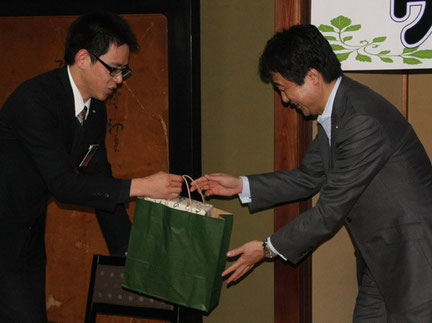 謝辞を述べ、岡西副知事に記念品を手渡す、綾部青年会議所の岡田太郎副理事長