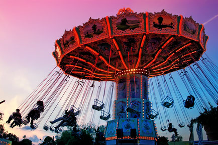 Merry-go-round spinning with people against the sunset sky Copyright pryzmat