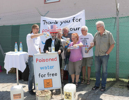 Unsere heutige Aktion vor der US-Kaserne in Katterbach, auf dem zu sehen ist, wie OLA-Mitglieder "Uncle Sam" symbolisch das verseuchte Trinkwasser aus Ansbacher Hausbrunnen vor die Füße kippen.