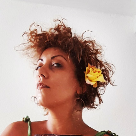 Das Bild zeigt die Autorin mit Blume im Haar.