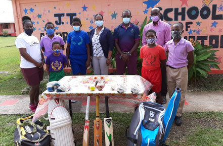 Cricket Kindness Ambassadors, Sir Richie Richardson & Commissioner of Sport, the Hon. Colin James present JT Ambrose with equipment shipped from England on behalf of the Cricket Kindness Project.  