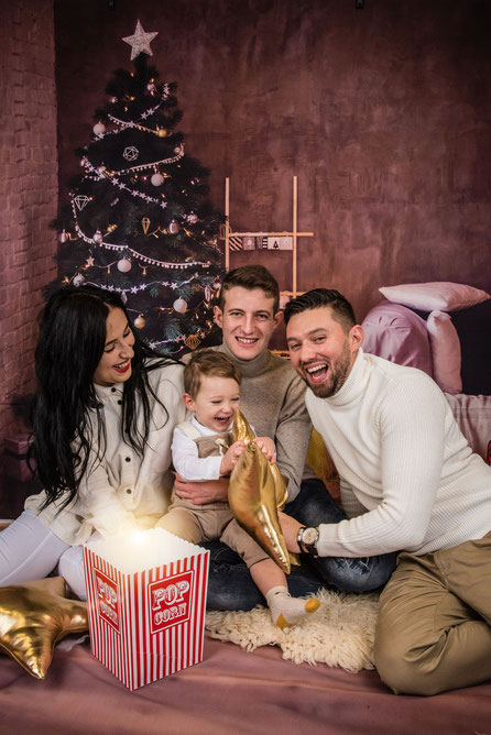kind met ouders bij kerstboom