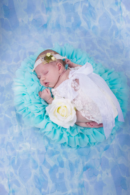 newborn in white dress