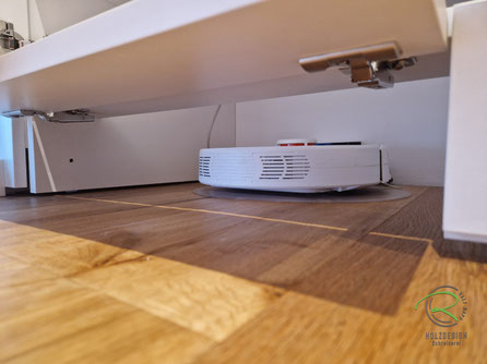 Flurschrank in weiß mit Geöffnete Klappe der elektrischen Staubsaugerroboter-Garage