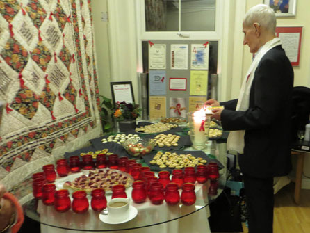 A member of Body Positive lighting a candle at the Aids Day Memorial Service.