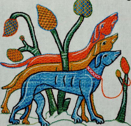 Three stylised embroidered hounds, in orange, bright orange and blue, standing in front of a stylised tree.