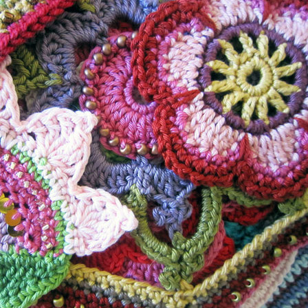 Brightly coloured crocheted flowers.