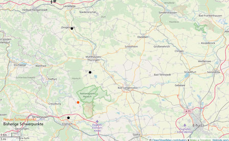 Map of Germany in which all of Germany's centers of gravity are shown in black and the newly calculated gravity point of Germany based on the squaring method is marked in orange.