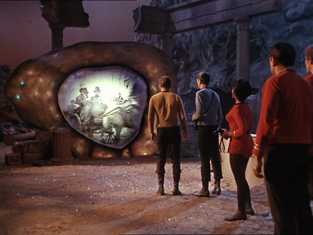 Still from Episode 28 of Star Trek called "The City on the Edge of Forever". Still shows crew of USS Enterprise looking through the time travel device known as the Guardian of Forever, and seeing images of the past.