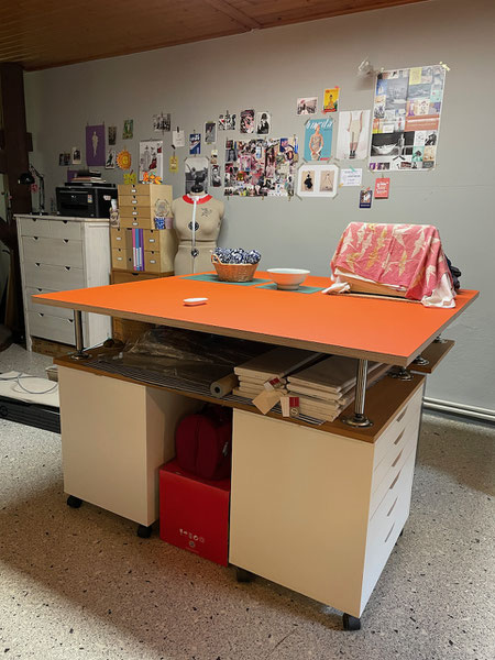 Homemade cutting table with orange linoleum surface. © Griselka 2021