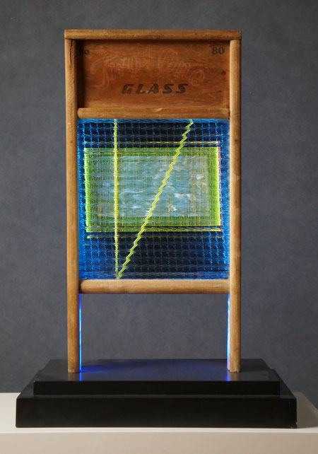 Assemblage light art sculpture made from an old glass washboard. This sculpture acts almost as a "light painting" with plexiglass, lenticular plastic, and LEDs placed in back.  The glass which refracts the light and the appearance of these components.