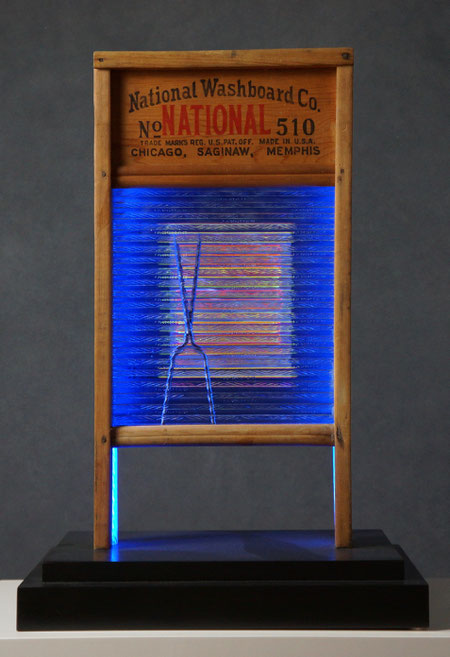 Assemblage light art sculpture made from an old glass washboard. This sculpture acts almost as a "light painting" with plexiglass, lenticular plastic, and LEDs placed in back.  The glass which refracts the light and the appearance of these components.